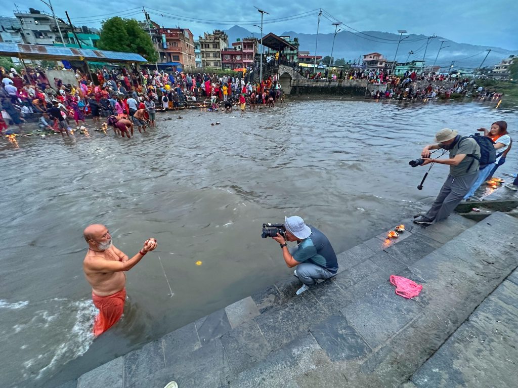 Chinese photographers take pictures on the bank of Bagmati river at Gokarneshwar temple in Kathmandu.