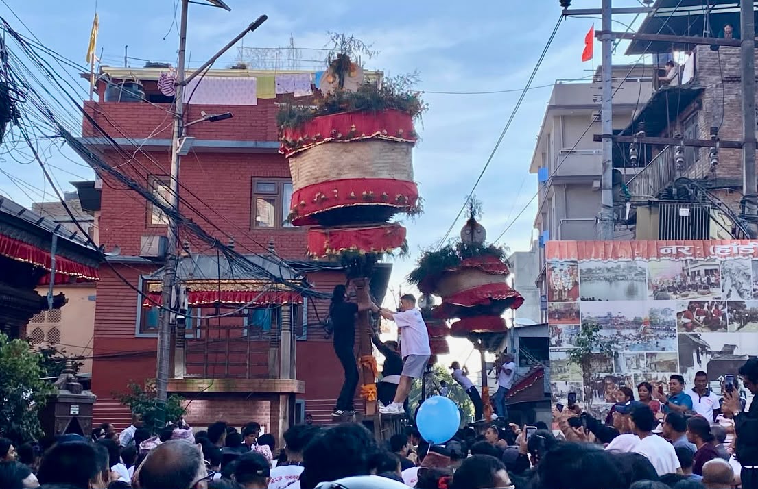 Devotees climb the khat as crowds watch during Hadigaun Jatra