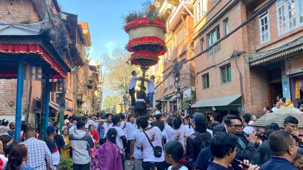 Hadigaun Jatra khat rising above the crowd in Hadigaun, Kathmandu